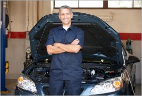 Owner of The Bridge Auto Philadelphia standing in front of his shop.