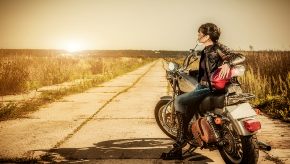 Man sitting on top of his motorcycle.